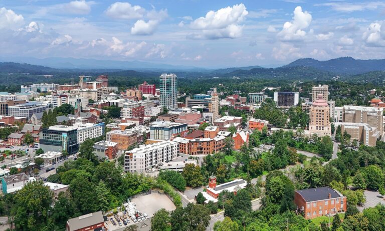 Aerial view of downtown Asheville, North Carolina, with the Buncombe County Courthouse, City Hall and the Jackson Building in front of the Blue Ridge Mountains