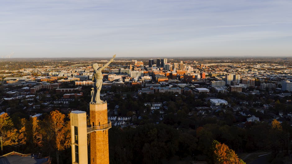 Drone capture of the Vulcan statue with Birmingham city skyline at sunset, Alabama.