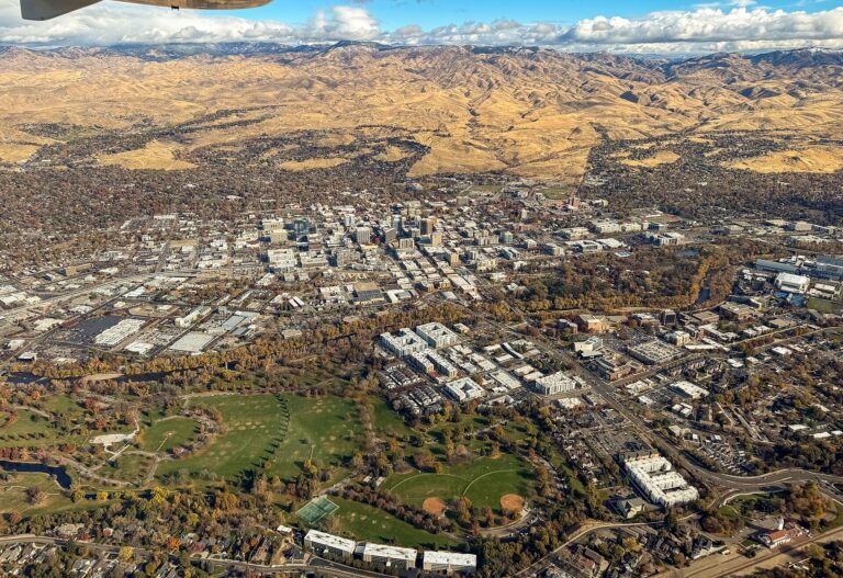 Aerial view of downtown Boise, Idaho, with Ann Morrison Park in the foreground and the Boise Foothills behind, November 2024