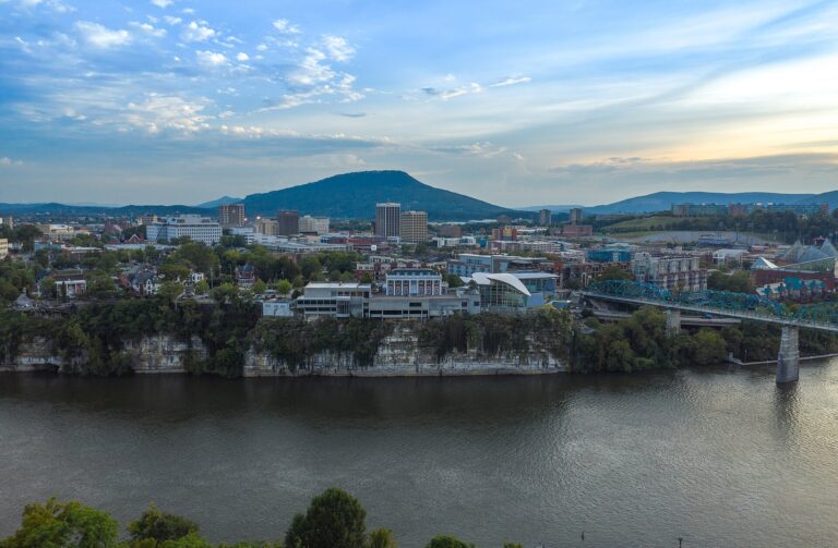 Downtown Chattanooga seen across the Tennessee River from North Shore, with the Walnut Street Bridge and Lookout Mountain behind the skyline