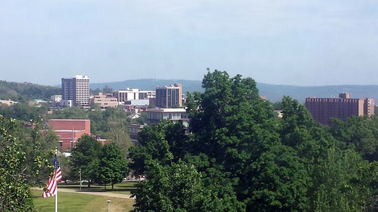 Downtown Fayetteville, Arkansas skyline seen over trees from Old Main on the University of Arkansas campus