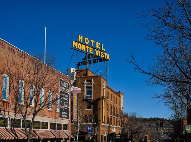 A downtown Flagstaff, Arizona street on a winter afternoon, with the Hotel Monte Vista sign on a rooftop