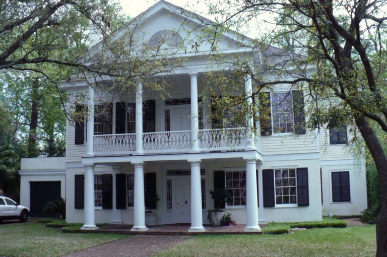 Two-story white house with a columned double porch at 1157 Palmetto Street in Mobile, Alabama