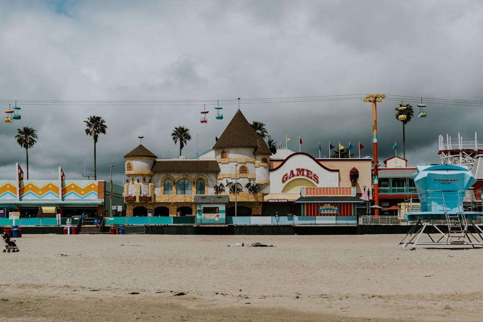 Vibrant Santa Cruz Beach Boardwalk with rides and cloudy sky.