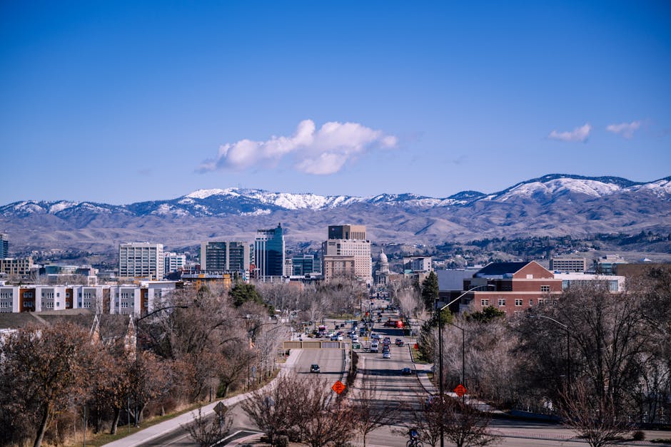 A stunning view of downtown Boise, Idaho, featuring mountains and clear blue skies.