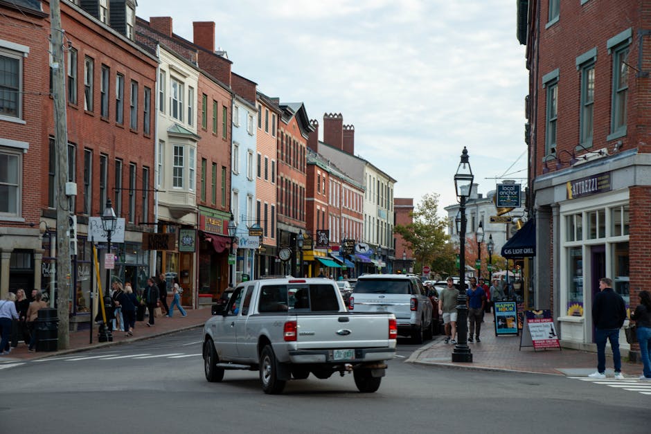 Vibrant street view of downtown Portsmouth, New Hampshire, with historic architecture and people walking.