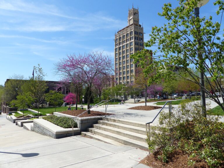 Pack Square Park in downtown Asheville, North Carolina, with redbud trees in bloom and the Jackson Building behind