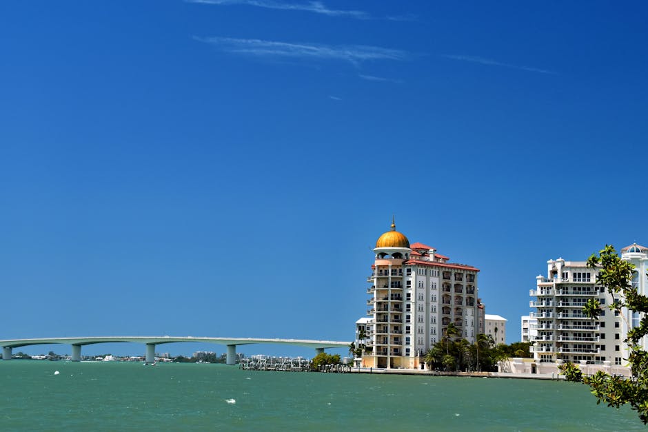 Stunning waterfront view of Sarasota's skyline and bridge under a clear blue sky.