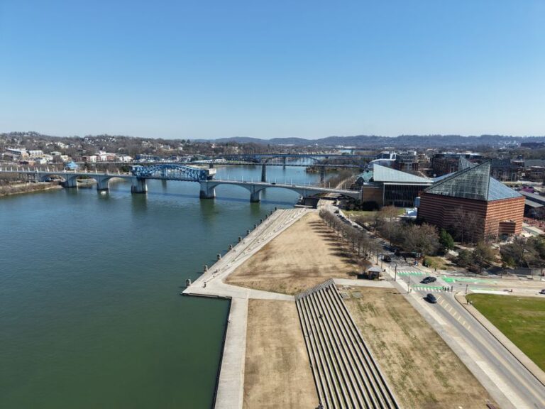 Aerial view of Chattanooga featuring the Walnut Street Bridge and Tennessee River on a clear day.