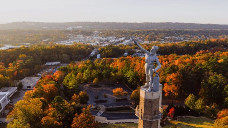 Aerial shot of the famous Vulcan statue overlooking Birmingham's fall foliage.