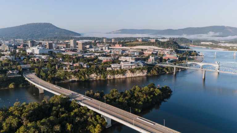 Stunning aerial view of Chattanooga's skyline with bridges and mountains in the background.
